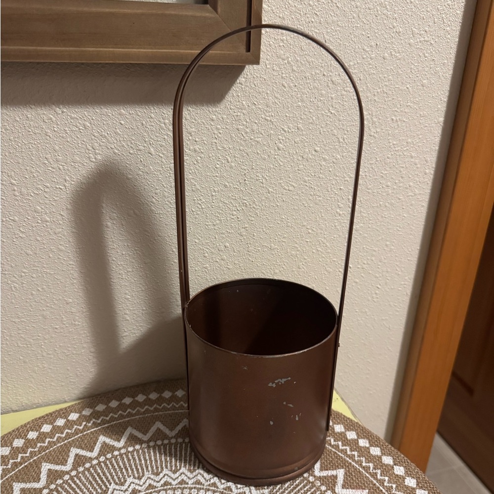 Brown Metal Planter basket in a bronze color